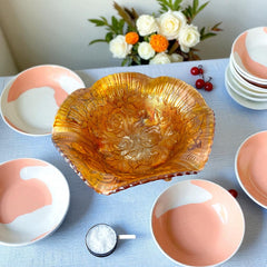 Vintage Imperial Glass marigold carnival bowl with Lustre Rose pattern, iridescent finish, scalloped edge, and three-footed base.