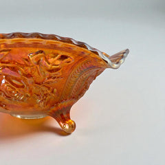 Vintage Imperial Glass marigold carnival bowl with Lustre Rose pattern, iridescent finish, scalloped edge, and three-footed base.