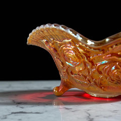 Vintage Imperial Glass marigold carnival bowl with Lustre Rose pattern, iridescent finish, scalloped edge, and three-footed base.