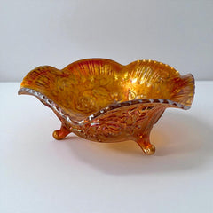 Vintage Imperial Glass marigold carnival bowl with Lustre Rose pattern, iridescent finish, scalloped edge, and three-footed base.