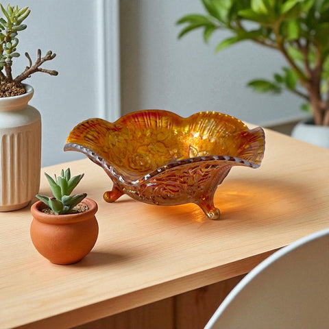 Vintage Imperial Glass marigold carnival bowl with Lustre Rose pattern, iridescent finish, scalloped edge, and three-footed base.
