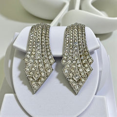 Vintage Carolee clip-on earrings with silver-tone Art Deco design and clear pave rhinestones; signed and in very good condition, circa 1980s.