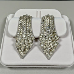 Vintage Carolee clip-on earrings with silver-tone Art Deco design and clear pave rhinestones; signed and in very good condition, circa 1980s.