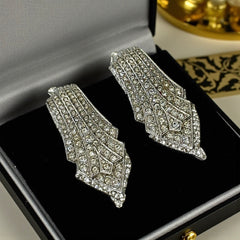 Vintage Carolee clip-on earrings with silver-tone Art Deco design and clear pave rhinestones; signed and in very good condition, circa 1980s.