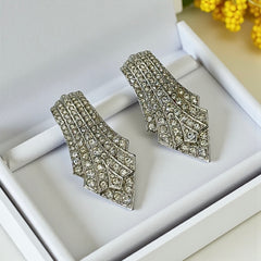 Vintage Carolee clip-on earrings with silver-tone Art Deco design and clear pave rhinestones; signed and in very good condition, circa 1980s.
