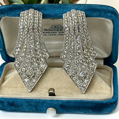 Vintage Carolee clip-on earrings with silver-tone Art Deco design and clear pave rhinestones; signed and in very good condition, circa 1980s.