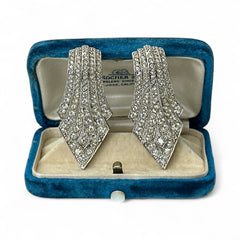 Vintage Carolee clip-on earrings with silver-tone Art Deco design and clear pave rhinestones; signed and in very good condition, circa 1980s.