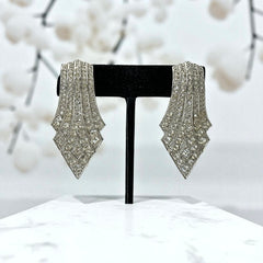 Vintage Carolee clip-on earrings with silver-tone Art Deco design and clear pave rhinestones; signed and in very good condition, circa 1980s.