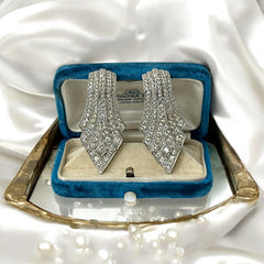 Vintage Carolee clip-on earrings with silver-tone Art Deco design and clear pave rhinestones; signed and in very good condition, circa 1980s.