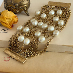 Vintage Carolee bracelet with ten strands of faux pearls and gold‑tone chains and a sculptural bar clasp.