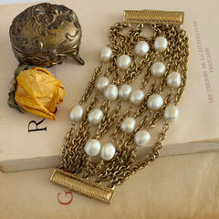Vintage Carolee bracelet with ten strands of faux pearls and gold‑tone chains and a sculptural bar clasp.