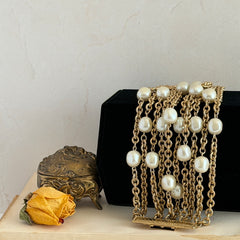 Vintage Carolee bracelet with ten strands of faux pearls and gold‑tone chains and a sculptural bar clasp.