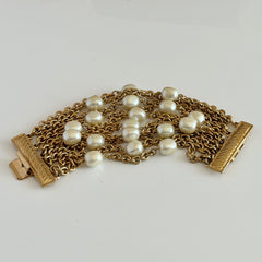 Vintage Carolee bracelet with ten strands of faux pearls and gold‑tone chains and a sculptural bar clasp.