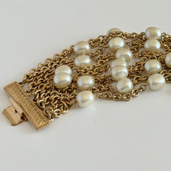 Vintage Carolee bracelet with ten strands of faux pearls and gold‑tone chains and a sculptural bar clasp.