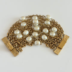 Vintage Carolee bracelet with ten strands of faux pearls and gold‑tone chains and a sculptural bar clasp.