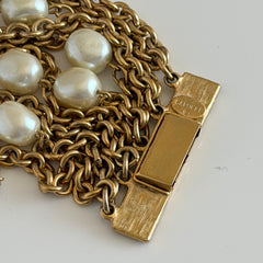 Vintage Carolee bracelet with ten strands of faux pearls and gold‑tone chains and a sculptural bar clasp.