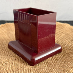Vintage maroon Carvanite Shuffle Cut card shuffler by Lea Industries, shown on burlap fabric.