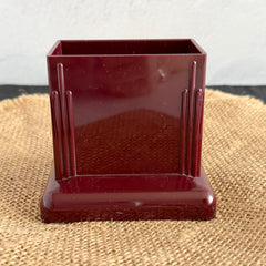 Vintage maroon Carvanite Shuffle Cut card shuffler by Lea Industries, shown on burlap fabric.
