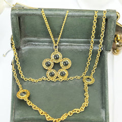 Vintage Celebrity gold‑tone necklace with gray glass chicklet elements, featuring a five‑round floral pendant and multiple convertible strands.