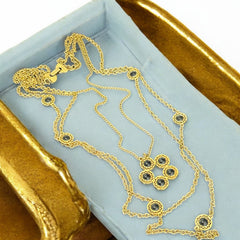 Vintage Celebrity gold‑tone necklace with gray glass chicklet elements, featuring a five‑round floral pendant and multiple convertible strands.