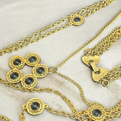 Vintage Celebrity gold‑tone necklace with gray glass chicklet elements, featuring a five‑round floral pendant and multiple convertible strands.