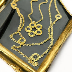 Vintage Celebrity gold‑tone necklace with gray glass chicklet elements, featuring a five‑round floral pendant and multiple convertible strands.