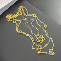 Vintage Celebrity gold‑tone necklace with gray glass chicklet elements, featuring a five‑round floral pendant and multiple convertible strands.