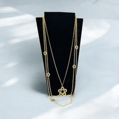 Vintage Celebrity gold‑tone necklace with gray glass chicklet elements, featuring a five‑round floral pendant and multiple convertible strands.