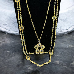 Vintage Celebrity gold‑tone necklace with gray glass chicklet elements, featuring a five‑round floral pendant and multiple convertible strands.