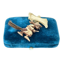 Vintage French brooch depicting a witch flying on a broom, crafted from celluloid with horsehair bristles; she wears a headscarf and holds a wand, mid-century design from the 1950s–60s, approx. 1¾" x 1½", in very good condition with secure pin back and folk-inspired detailing.
