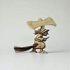 Vintage French brooch depicting a witch flying on a broom, crafted from celluloid with horsehair bristles; she wears a headscarf and holds a wand, mid-century design from the 1950s–60s, approx. 1¾" x 1½", in very good condition with secure pin back and folk-inspired detailing.