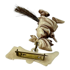 Vintage French brooch depicting a witch flying on a broom, crafted from celluloid with horsehair bristles; she wears a headscarf and holds a wand, mid-century design from the 1950s–60s, approx. 1¾" x 1½", in very good condition with secure pin back and folk-inspired detailing.