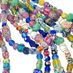 A strand of vintage Chinese lampwork beads from the 1990s, featuring colorful floral and geometric designs in various shapes like oval, cube, and round tube. Each strand includes approximately 20 unique glass beads, new old stock, with a vibrant and playful aesthetic.