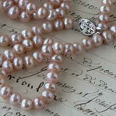 Vintage Chinese light pink freshwater pearl necklace with silver‑tone clasp engraved with Chinese characters.
