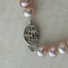 Vintage Chinese light pink freshwater pearl necklace with silver‑tone clasp engraved with Chinese characters.
