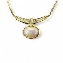 Vintage 1970s Christian Dior necklace featuring a luminous faux pearl pendant accented with pave rhinestones, suspended from a gold plated cobra chain with adjustable spring ring clasp and signed ChrDior © hang tag.