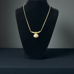 Vintage 1970s Christian Dior necklace featuring a luminous faux pearl pendant accented with pave rhinestones, suspended from a gold plated cobra chain with adjustable spring ring clasp and signed ChrDior © hang tag.