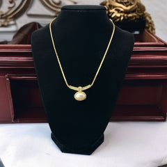 Vintage 1970s Christian Dior necklace featuring a luminous faux pearl pendant accented with pave rhinestones, suspended from a gold plated cobra chain with adjustable spring ring clasp and signed ChrDior © hang tag.