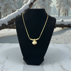 Vintage 1970s Christian Dior necklace featuring a luminous faux pearl pendant accented with pave rhinestones, suspended from a gold plated cobra chain with adjustable spring ring clasp and signed ChrDior © hang tag.