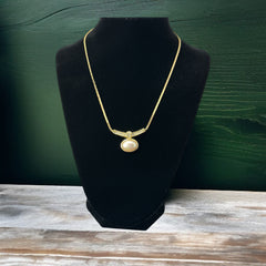 Vintage 1970s Christian Dior necklace featuring a luminous faux pearl pendant accented with pave rhinestones, suspended from a gold plated cobra chain with adjustable spring ring clasp and signed ChrDior © hang tag.