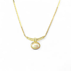Vintage 1970s Christian Dior necklace featuring a luminous faux pearl pendant accented with pave rhinestones, suspended from a gold plated cobra chain with adjustable spring ring clasp and signed ChrDior © hang tag.