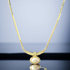 Vintage 1970s Christian Dior necklace featuring a luminous faux pearl pendant accented with pave rhinestones, suspended from a gold plated cobra chain with adjustable spring ring clasp and signed ChrDior © hang tag.