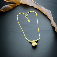 Vintage 1970s Christian Dior necklace featuring a luminous faux pearl pendant accented with pave rhinestones, suspended from a gold plated cobra chain with adjustable spring ring clasp and signed ChrDior © hang tag.