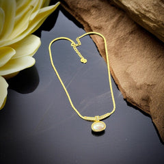Vintage 1970s Christian Dior necklace featuring a luminous faux pearl pendant accented with pave rhinestones, suspended from a gold plated cobra chain with adjustable spring ring clasp and signed ChrDior © hang tag.