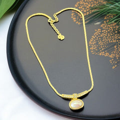 Vintage 1970s Christian Dior necklace featuring a luminous faux pearl pendant accented with pave rhinestones, suspended from a gold plated cobra chain with adjustable spring ring clasp and signed ChrDior © hang tag.