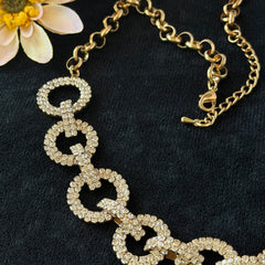 Vintage gold tone necklace with interlocking clear rhinestone circle links and lobster clasp.
