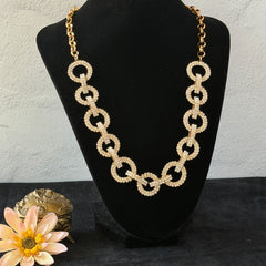 Vintage gold tone necklace with interlocking clear rhinestone circle links and lobster clasp.
