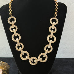 Vintage gold tone necklace with interlocking clear rhinestone circle links and lobster clasp.