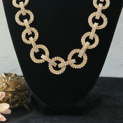 Vintage gold tone necklace with interlocking clear rhinestone circle links and lobster clasp.