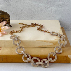 Vintage gold tone necklace with interlocking clear rhinestone circle links and lobster clasp.